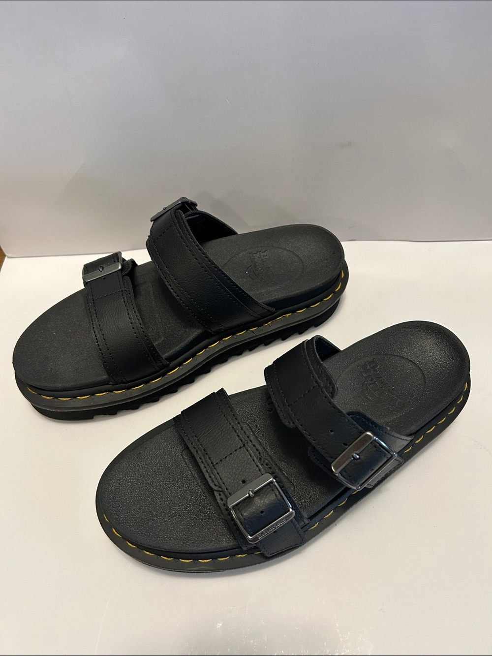 Dr. Martens women’s Black Double-Strap Buckle Slides with Yellow Stitching